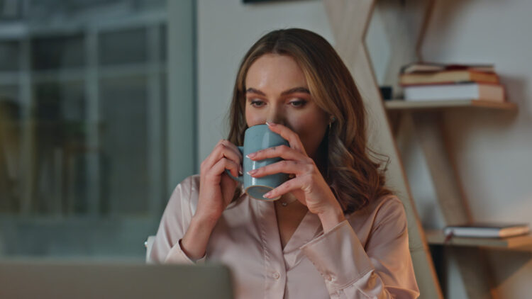 A person drinking a cold beverage